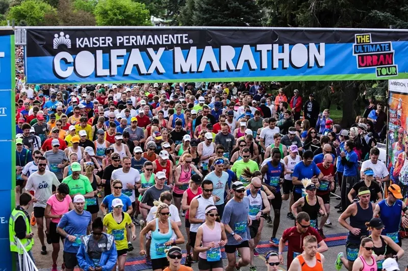 Image: Runners take off under a banner reading "Colfax Marathon"