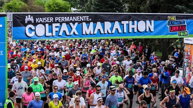 Runners take off under a banner reading "Colfax Marathon"