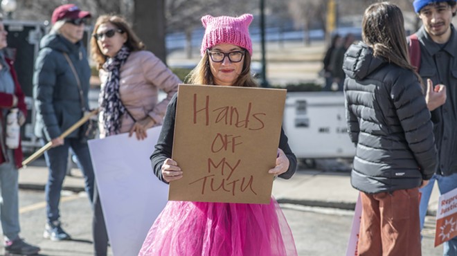 woman in pink tutu and hat with sign supporting abortion