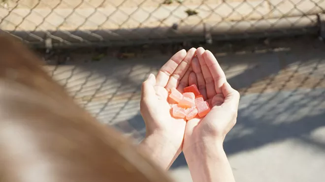 Hands holding CBD gummies