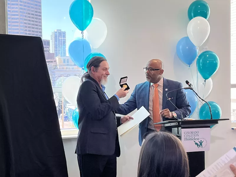 Image: Mayor Michael Hancock honoring John Parvensky with a City Coin.
