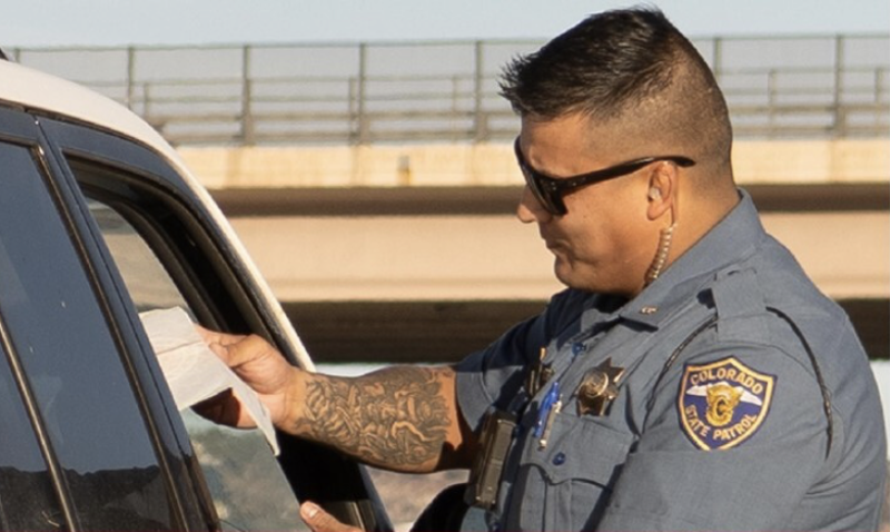 Image: A police officer standing at a car door