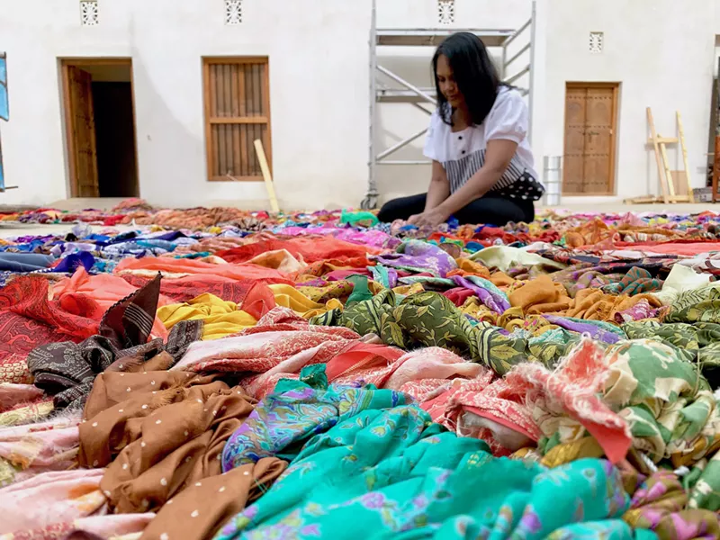 Image: Suchitra Mattai with sari tapestries in Sharjah, India.
