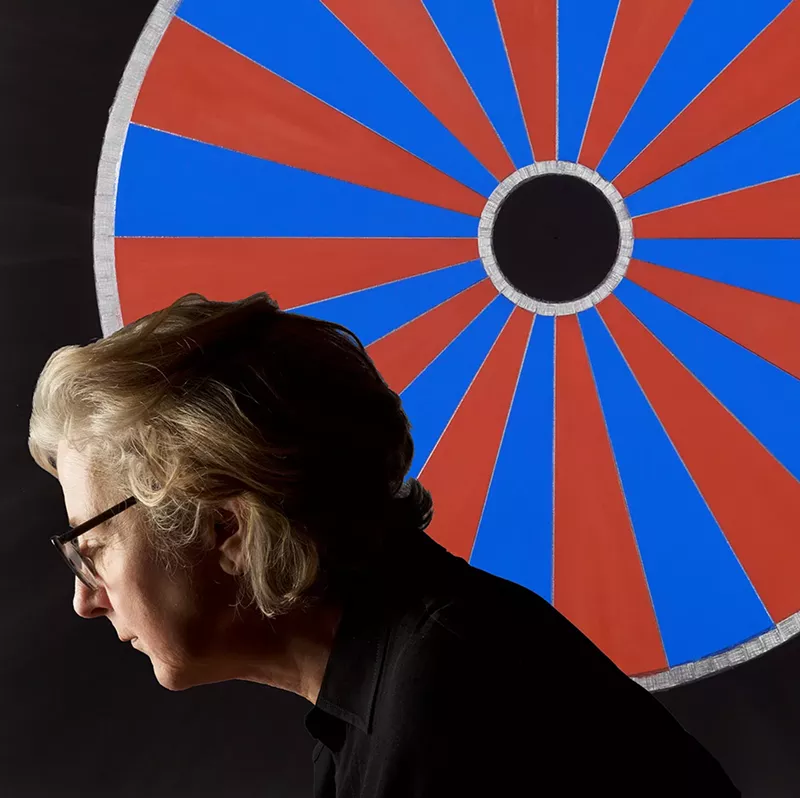 Image: Sherry Wiggins in front of one of her abstract geometric drawings, "Out of India."