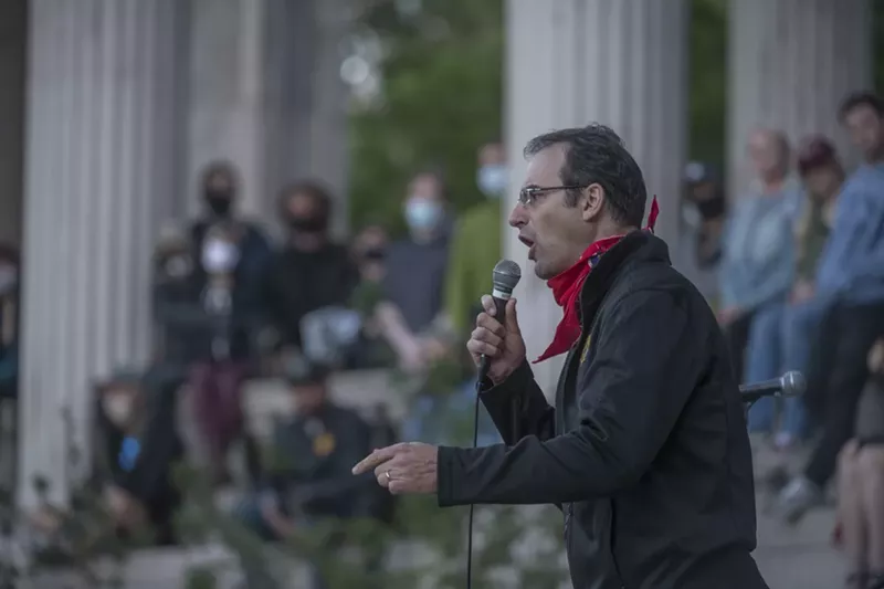 Image: Man speaks to crowd