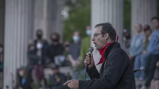 Man speaks to crowd