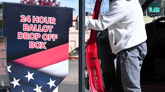 man drops off election ballot in dropoff box