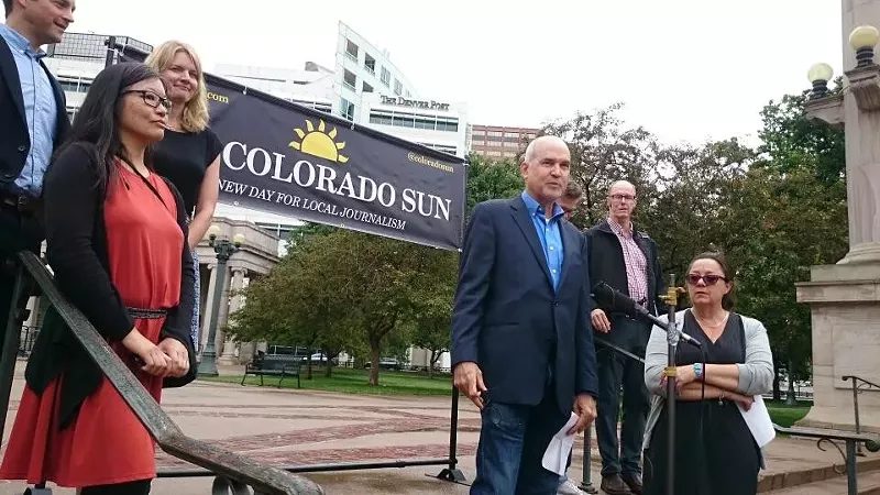 Image: Colorado Sun editor Larry Ryckman stands before the microphone at a June 18 news conference held in Civic Center Park, in front of the old Denver Post building. Left to right: John Ingold, Tamara Chuang, Jennifer Brown, Ryckman, Jason Blevins (partially obscured), Kevin Simpson and Dana Coffield.