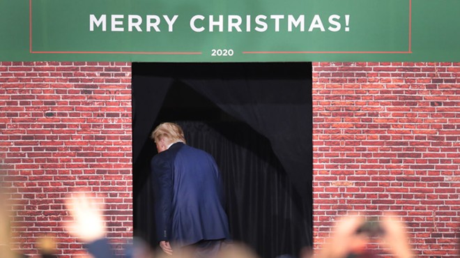 trump exiting through door with Merry Christmas sign