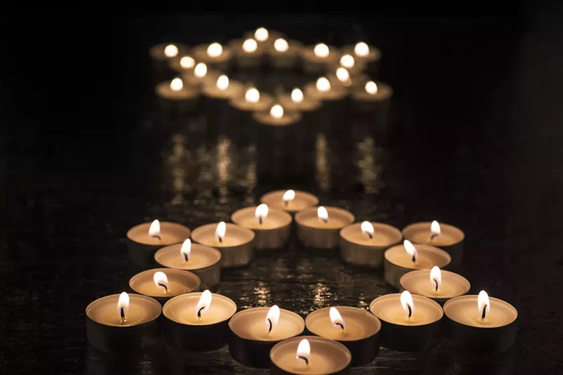 Image: Collections fo tea candles form two stars of David.