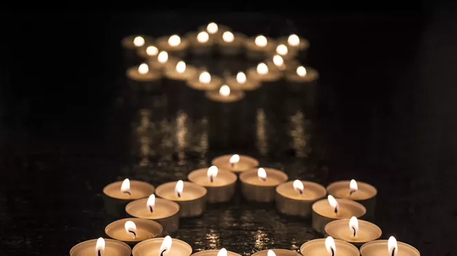 Collections fo tea candles form two stars of David.