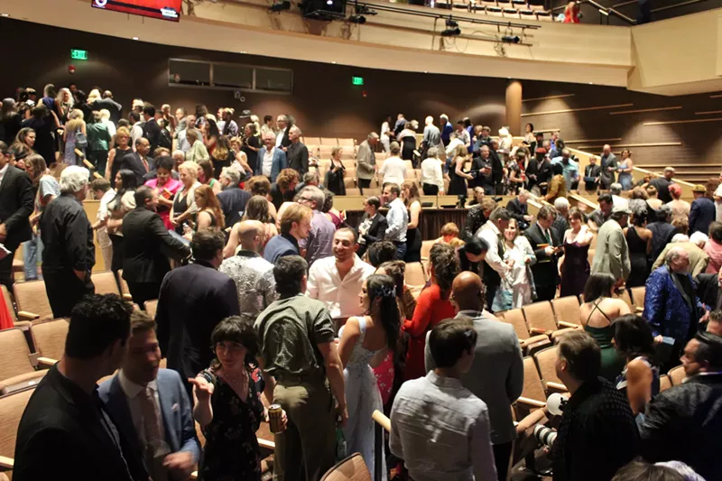 Image: people sitting in an auditorium