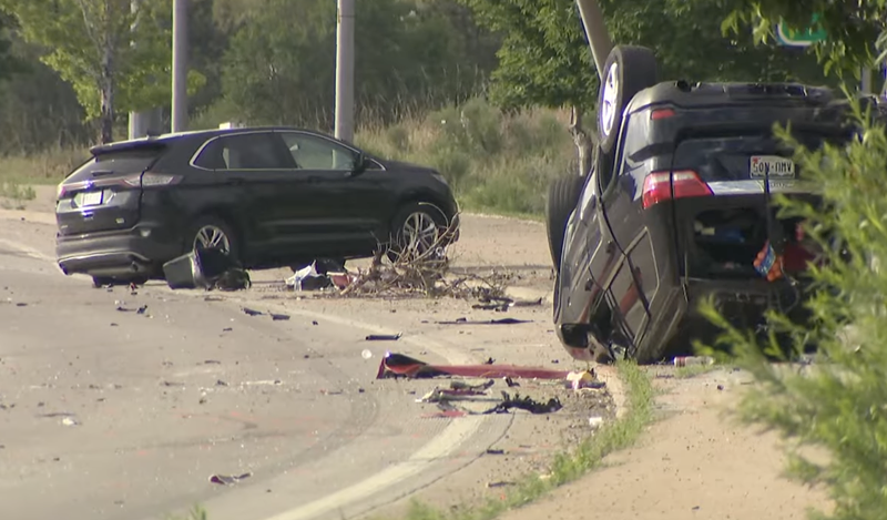 Image: Cars smashed up on a road after an accident.