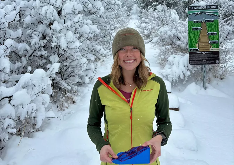 Image: Erin Ton posing with a trophy at the base of the Manitou Incline after her record-breaking run.