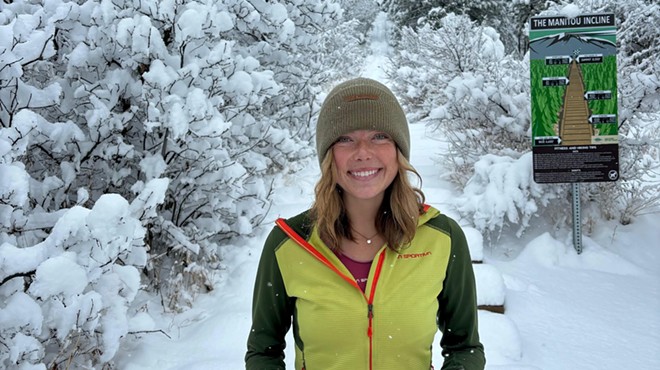 Erin Ton posing with a trophy at the base of the Manitou Incline after her record-breaking run.
