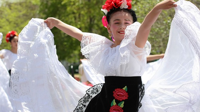 woman in Mexican dress dancing.