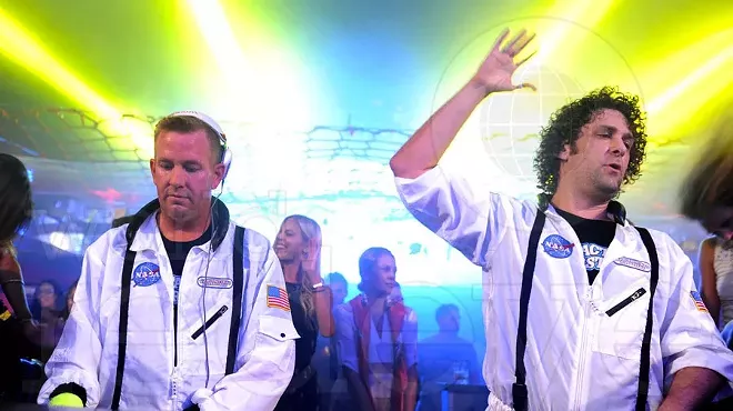 two djs performing