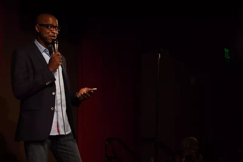 Image: Comedian Sam Adams performing a set for Denver Urban Spectrum's Comedy Explosion in 2017 at Comedy Works South