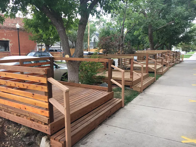 Image: Single-table decks offer outdoor seating at Sushi Den.