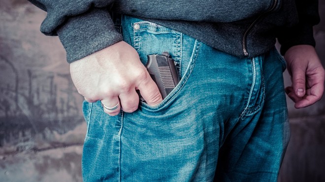gun in man's jean pocket