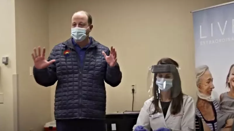 Image: Governor Jared Polis at the unboxing of the first COVID-19 vaccines to reach Colorado.