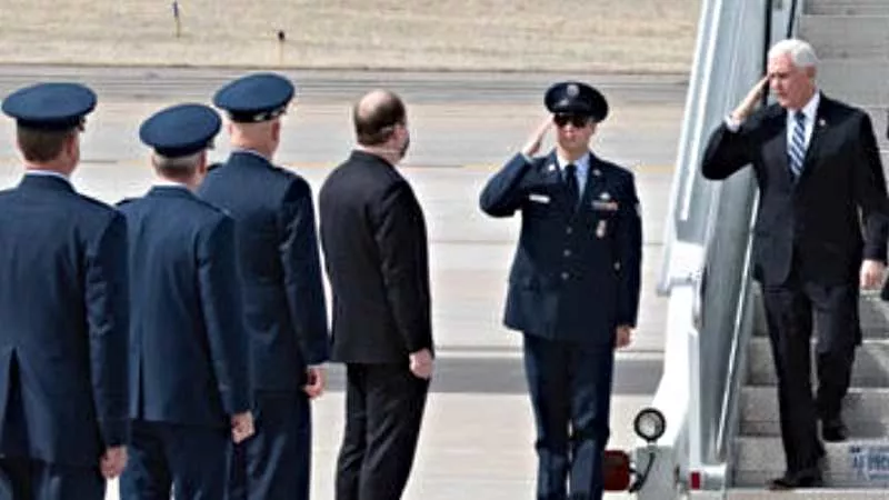 Image: A masked Colorado Governor Jared Polis greets Vice President Mike Pence sans face covering.