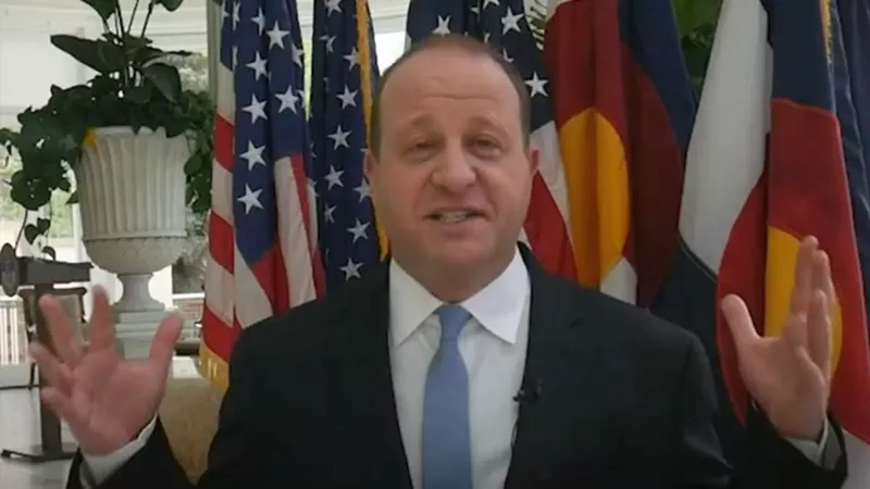 Image: Coiorado Governor Jared Polis as seen in a video congratulating University of Denver graduates.