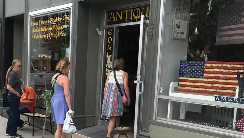 Image: Unmasked customers entering a downtown Cheyenne business on July 25.