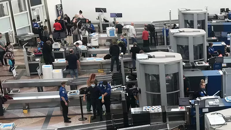 Image: Social distancing was spotty at the main DIA security station. Note the mask-free TSA employee at the lower right.