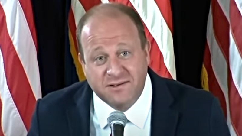 Governor Jared Polis beseeching Coloradans to "wear your damn mask" during a July 9 press conference.