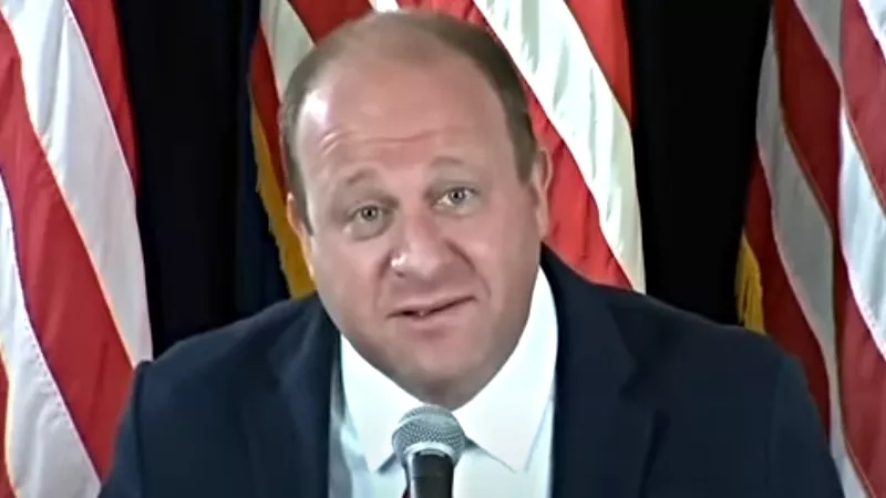 Image: Governor Jared Polis beseeching Coloradans to "wear your damn mask" during a July 9 press conference.