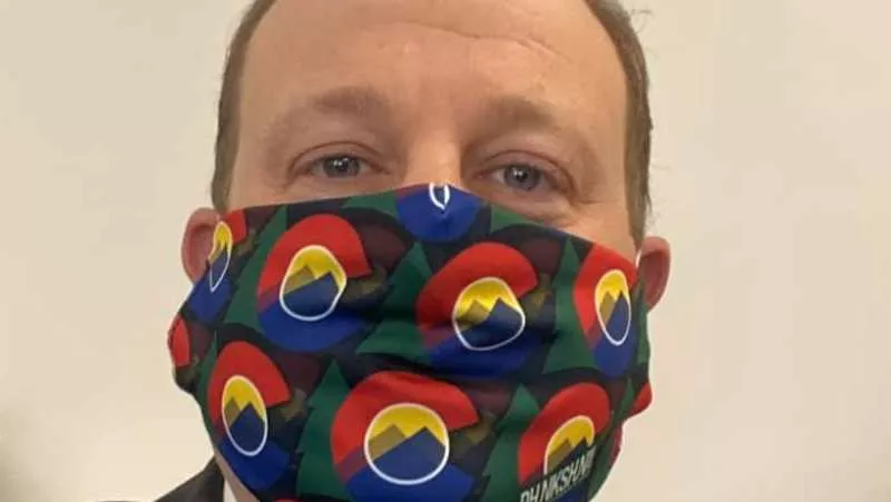 Image: Governor Jared Polis showing off a Colorado-centric mask.