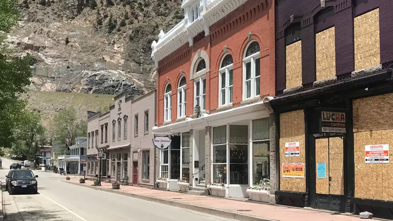 Image: Downtown Georgetown on a recent Sunday afternoon. The boarded-up restaurant to the right was damaged in a fire.