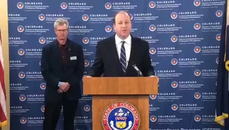 Image: Colorado Governor Jared Polis speaking at a March 25 press conference.