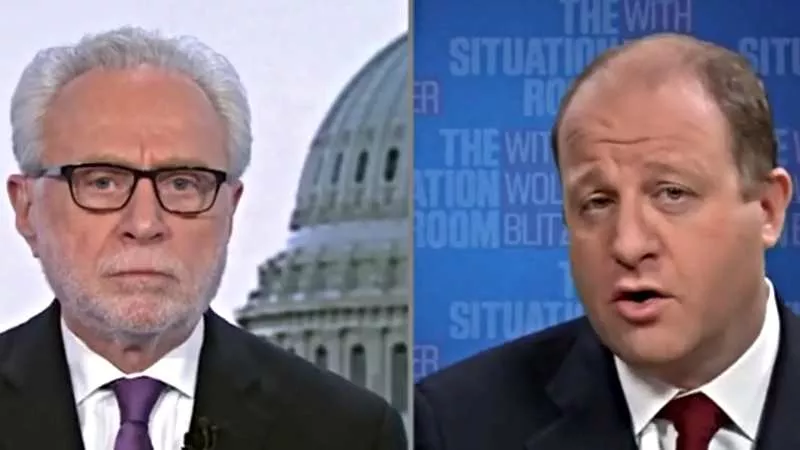 Image: Colorado Governor Jared Polis speaking to CNN's Wolf Blitzer during an interview on March 29.