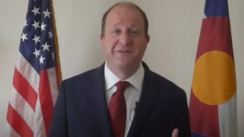 Image: Governor Jared Polis in a video thanking the Montbell company for donating personal protective equipment to the state.