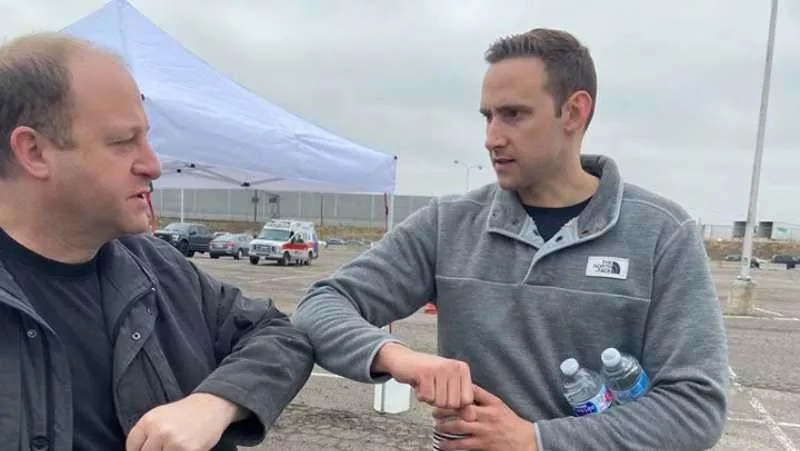 Image: Colorado Governor Jared Polis demonstrating the proper elbow-bump technique.