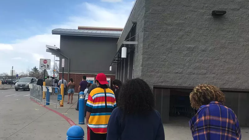 Image: The line outside the Aurora outbreak Walmart on May 2. The two women in the foreground weren't wearing masks, but left before entering the store.
