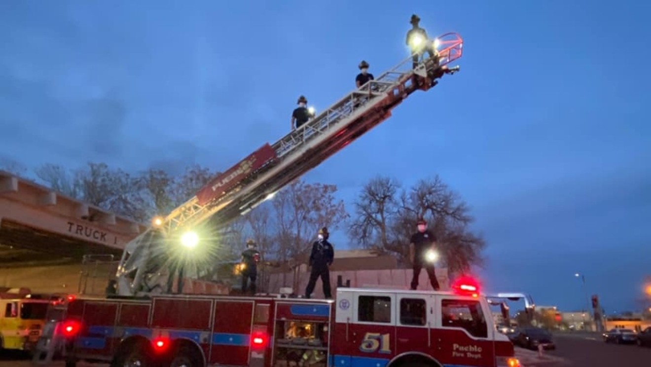 Members of the Pueblo Fire Department rising to new heights.