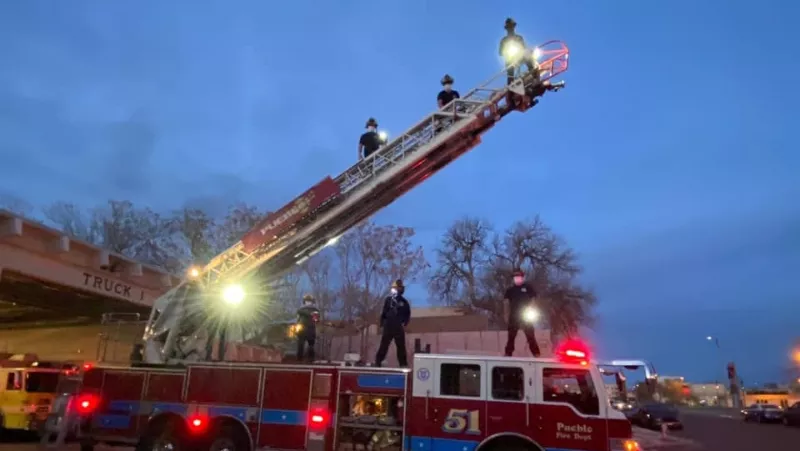 Image: Members of the Pueblo Fire Department rising to new heights.
