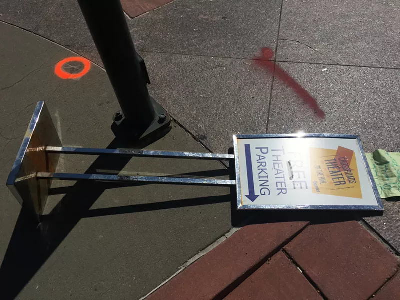 Image: A fallen sign for Crossroads parking on the sidewalk in Five Points.