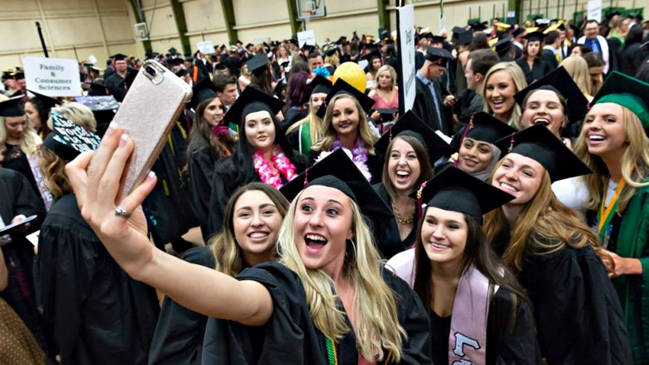 Colorado State University College of Health and Human Sciences strike a post at graduation this past May.