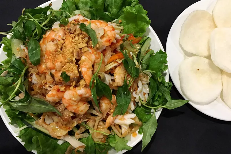 Image: The house salad, made with shrimp, squid, escargot, jellyfish, papaya, pineapple and other fresh herbs and vegetables.