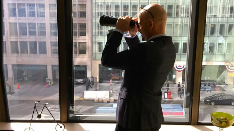 Image: Jason Flores-Williams, looking for trouble out the window of a law office he rented near the White House. Additional photos below.