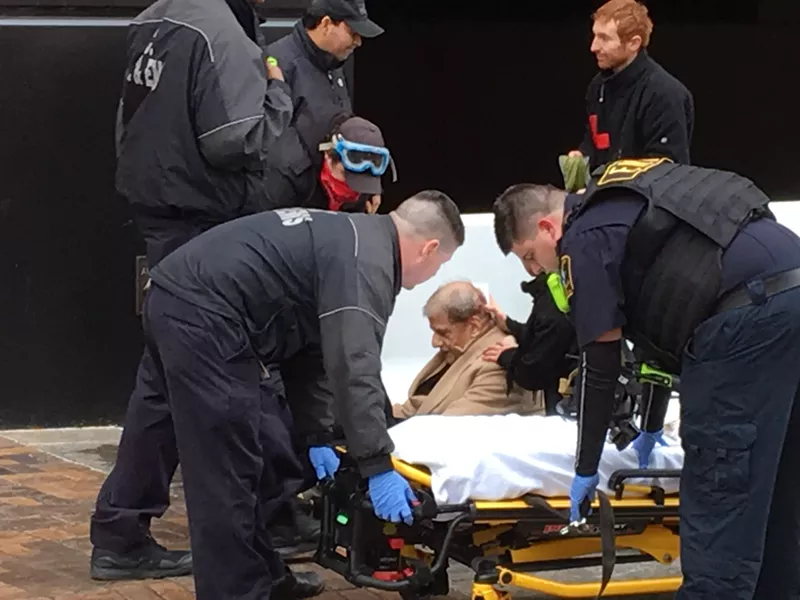 Image: A man injured during the riot is treated by EMTs.
