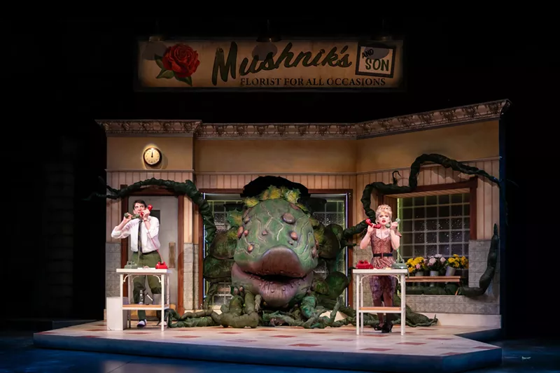 Image: The plant in Little Shop of Horrors looms large inside a flower shop.