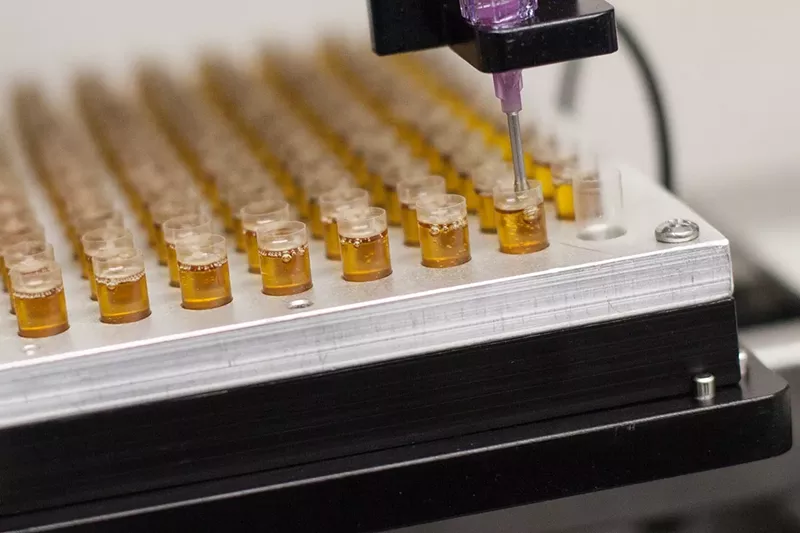 Image: Cannabis oil is loaded into a capsule at a Colorado extraction facility.