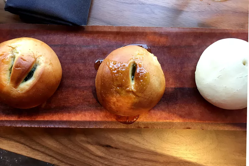 Image: Left to right: spinach, artichoke and chèvre bun; brisket and cream cheese bun; meatball steamed bun.