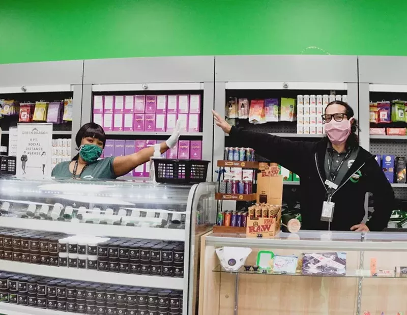 Image: Budtenders embrace social distancing guidelines during the COVID-19 pandemic.