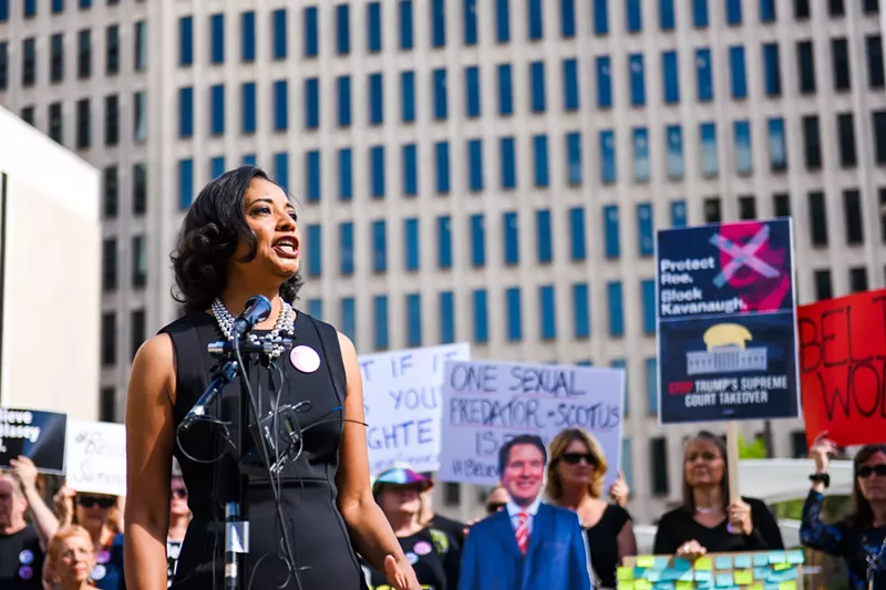 Image: Lisa Calderón speaking before a crowd at Monday morning's demonstration in front of Cory Gardner's office.
